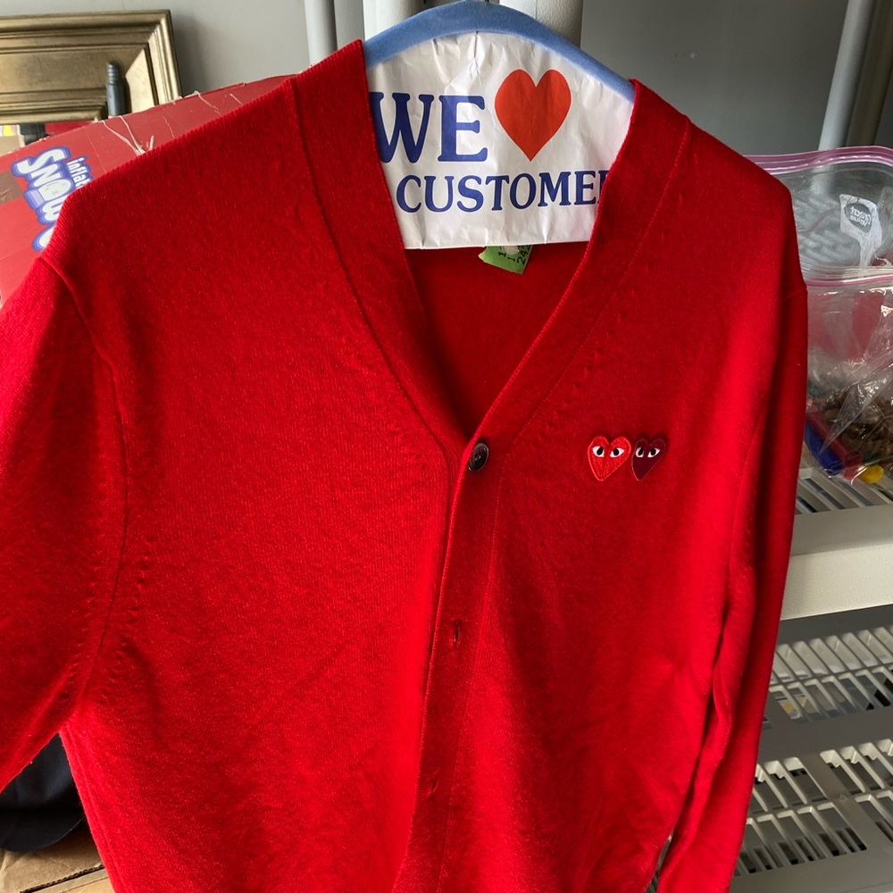 Red cardigan with iconic hearts